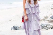With white framed sunglasses, red chain strap bag and lilac ruffled tiered sleeveless midi dress