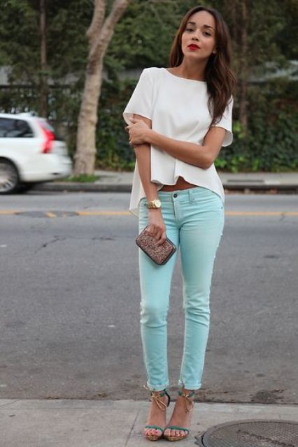 With white high low blouse, mini clutch and green ankle strap high heels