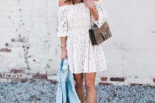 With white lace off the shoulder mini dress, brown suede chain strap bag, light blue denim jacket and metallic flat sandals