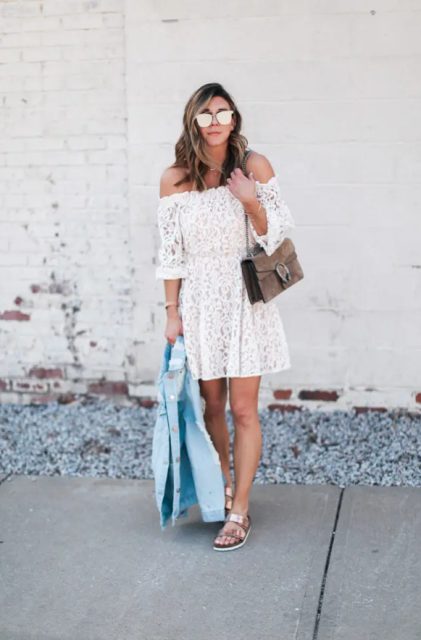 With white lace off the shoulder mini dress, brown suede chain strap bag, light blue denim jacket and metallic flat sandals