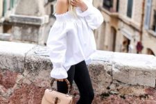 With white oversized off the shoulder bell sleeved blouse, black flare cropped pants and beige leather bag