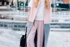 With white t-shirt, pale pink pleated culottes, black leather low heel shoes, black bag and pale pink and gray long vest