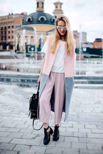 With white t-shirt, pale pink pleated culottes, black leather low heel shoes, black bag and pale pink and gray long vest