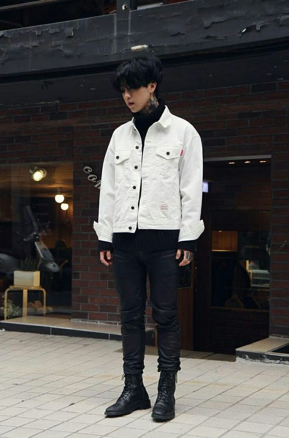 a bold and contrasting look with a black turtleneck, leather pants and combat boots, a white denim jacket