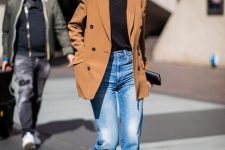 a bright and chic look with a black t-shirt, blue jeans, red boots, a camel blazer and a small black clutch for spring