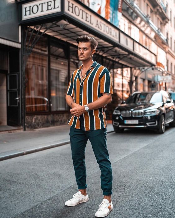 a bright vertical stripe short sleeved shirt, teal joggers, white sneakers and a white watch are great for spring or summer