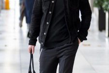 a casual outfit with a black turtleneck, a denim jacket, grey pants, black socks, white sneakers and a black tote