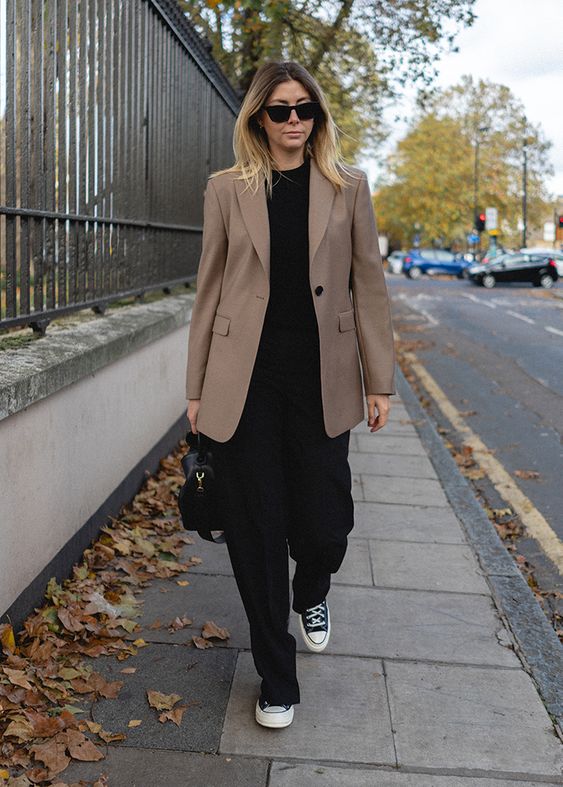 a catchy look with a black t-shirt, black pants, black sneakers, a beige oversized blazer and a black bag can be a fit for work