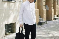 a classy monochromatic outfit with a white meo shirt, black cropped pants, white sneakers, a black tote