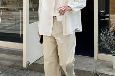 a classy neutral look with a white top and an oversized shirt, tan trousers, white sneakers is great for spring