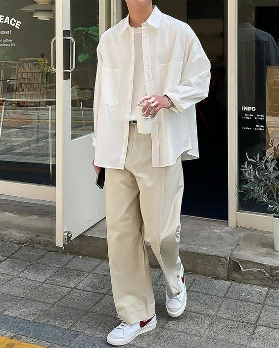 a classy neutral look with a white top and an oversized shirt, tan trousers, white sneakers is great for spring