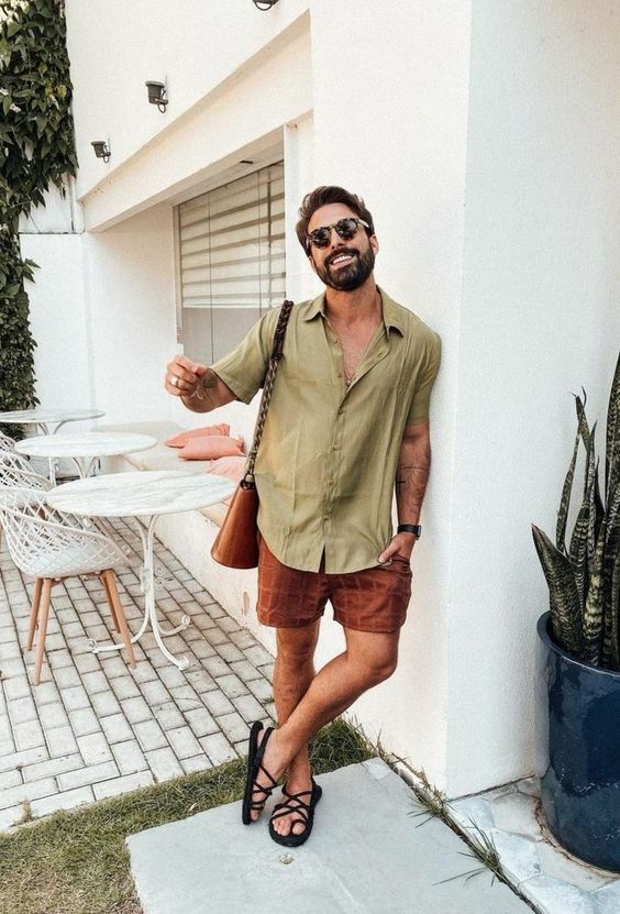 a comfortable summer outfit with a beige linen shirt, red checked shorts, black sandals, a brown bag is cool and easy to repeat