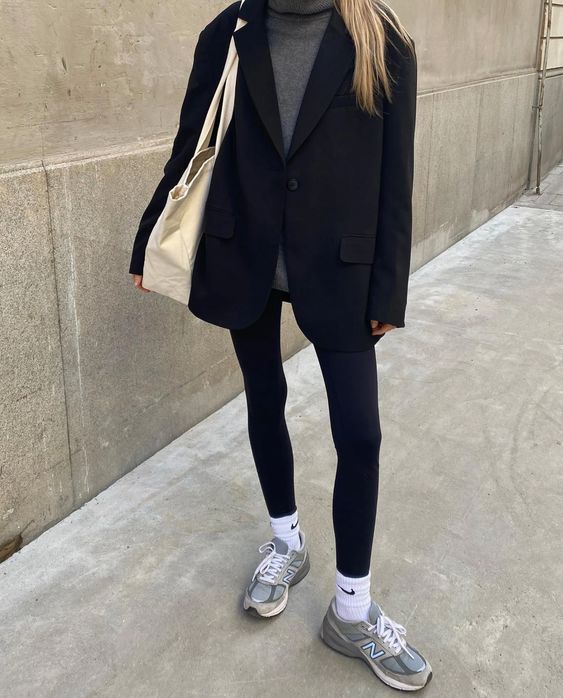 a grey turtleneck, an oversized black blazer, black leggings, white socks, grey trainers and a creamy tote