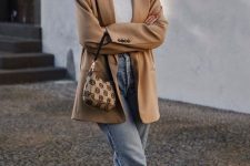 a lovely casual outfit with a white turtleneck, blue cropped jeans, snakeskin print loafers and a beige oversized blazer plus a printed bag