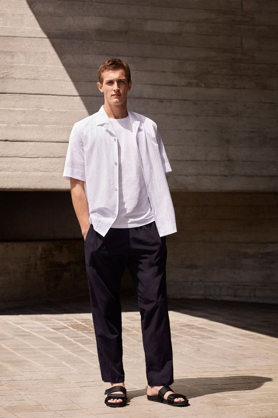 a minimalist summer look with a white tee, a white short-sleeved shirt, black pants and black sandals