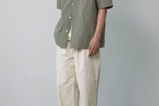 a neutral summer outfit with a neutral top, an olive green short-sleeved shirt, neutral pants, tan sneakers is a cool and minimal look