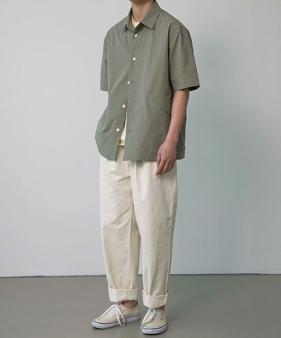a neutral summer outfit with a neutral top, an olive green short-sleeved shirt, neutral pants, tan sneakers is a cool and minimal look