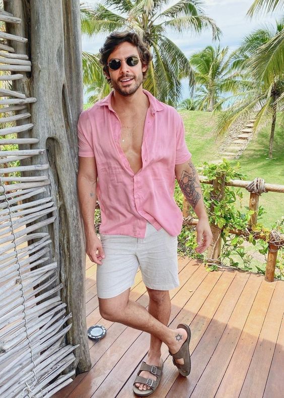 a pink linen shirt, neutral linen shorts, grey birkenstocks compose a nice and comfortable look for a hot day