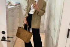 a stylish work outfit with a white t-shirt, a beige oversized blazer, black pants, nude shoes and a stylish suede bag