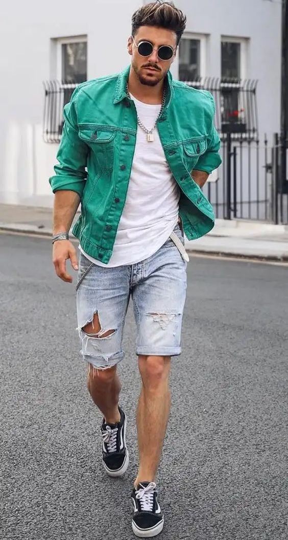 a summer outfit with a white tee, an emerald denim jacket, blue ripped shorts, black sneakers