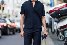 a total black look with a short-sleeved linen shirt, trousers, black snakers with colorful tops is a lovely idea for spring
