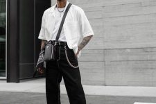 a trendy monochromatic outfit with a white t-sihrt, a white short-sleeved button down, white trainers and a black bag