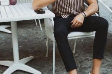 a vertical stripe short-sleeved shirt, black cropped jeans, white sneakers for a stylish and simple spring look