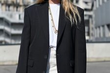 a white shirt, a white leather mini, an oversized black blazer, layered necklaces and a white tote for a spring to summer look