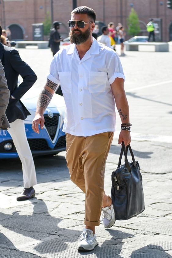 a white short-sleeved shirt, yellow trousers, grey trainers and a black leather bag are great for a summer day