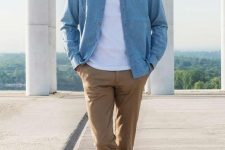 a white t-shirt, a blue chambray shirt, beige pants, white sneakers compose a comfortable and cool look for spring