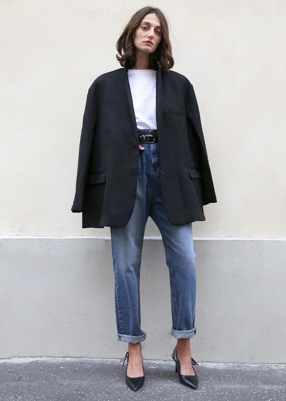 a white t-shirt, blue cuffed jeans, black slingbacks, an oversized black blazer compose a stylish work outfit or an everyday one