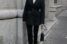 a white turtleneck, black straight jeans, a black oversized blazer, a belt, white shoes and a black bag for the office