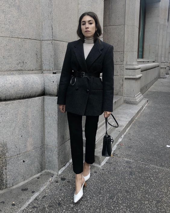 a white turtleneck, black straight jeans, a black oversized blazer, a belt, white shoes and a black bag for the office