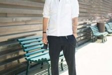 an edgy outfit with a white button down with cuffed sleeves, black cropped trousers and silver shoes is cool