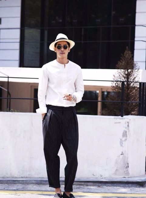 an elegant look with a touch of vintage, with a white mao shirt, thin striped pants, black loafers and a straw hat