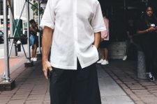 an elegant summer look with a white button down, black linen Bermuda shorts, black and white slipons