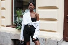 02 a black and white look with a spaghetti strap top, black biker shorts, black shoes, an oversized white shirt and a black bag