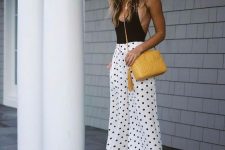 a black bodysuit, white polka dot culottes, clear heels and a yellow bag for a lovely and playful summer date or party look