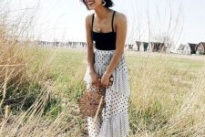 05 a catchy outfit for a special occasion – a black spaghetti strap top and a mixed print polka dot maxi skirt wiht a train, a wooden bag