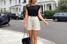 06 a black top with accented shoulders, tan linen shorts, black espadrilles and a black bag are a great combo for a hot summer day