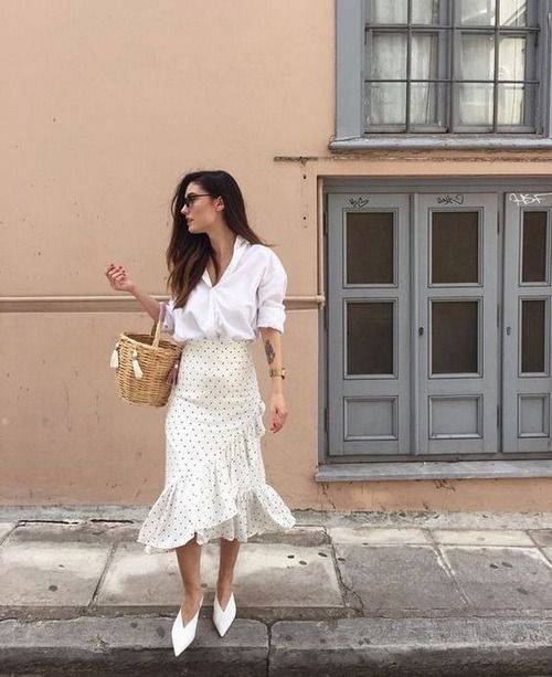 a girlish look with a white shirt, a neutral polka dot tiered midi skirt, white shoes and a basket instead of a bag