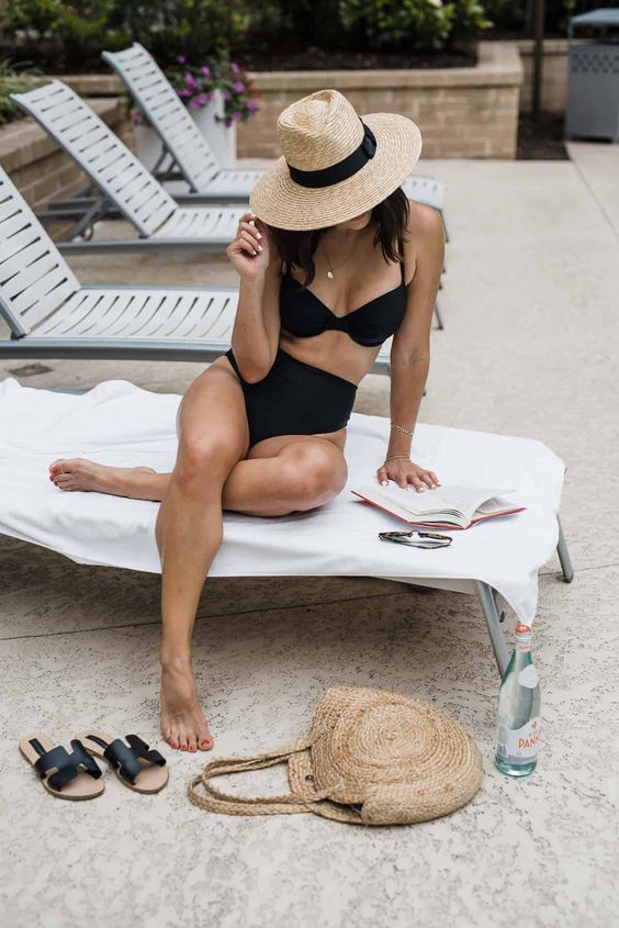 a modern and simple black bikini with a comfy bra and a high waisted top, a straw hat and black slides