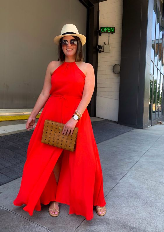 a red halter neckline maxi dress wiht a front slit, a printed clutch embellished shoes and a straw hat for a sumemr brunch