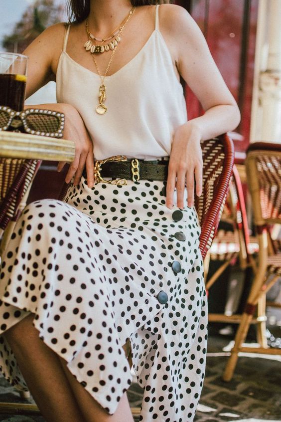 a lovely summer outfit with a neutral top, a black and white polka dot button up skirt, a black belt and layered necklaces