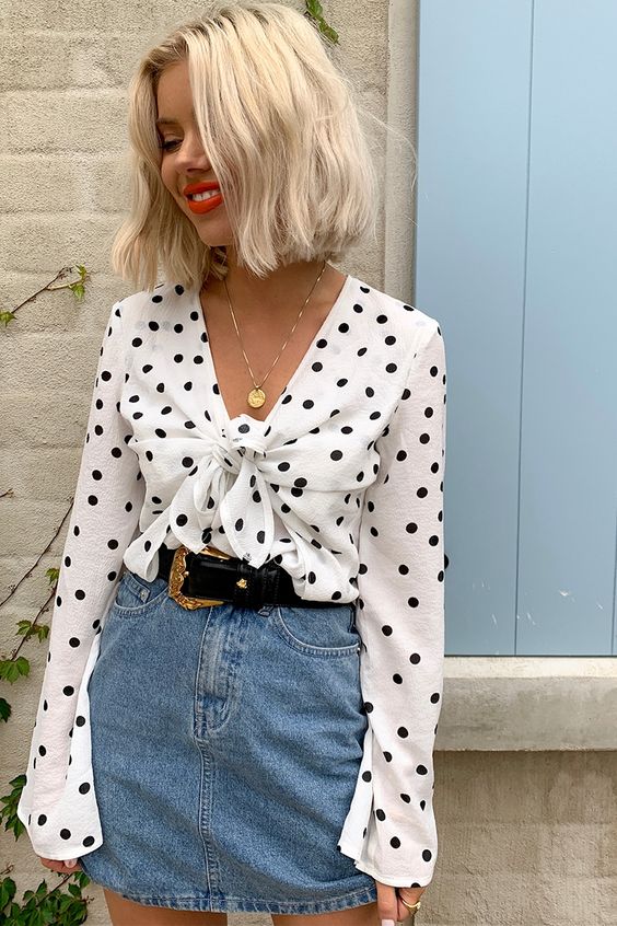 a playful and girlish look with a black and white polka dot tied up shirt, a blue denim mini and a black belt is a great idea for a summer date