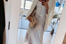 12 a white tank top, a striped midi skirt, a creamy blazer and snakeskin print shoes plus a tan pouch for summer work look