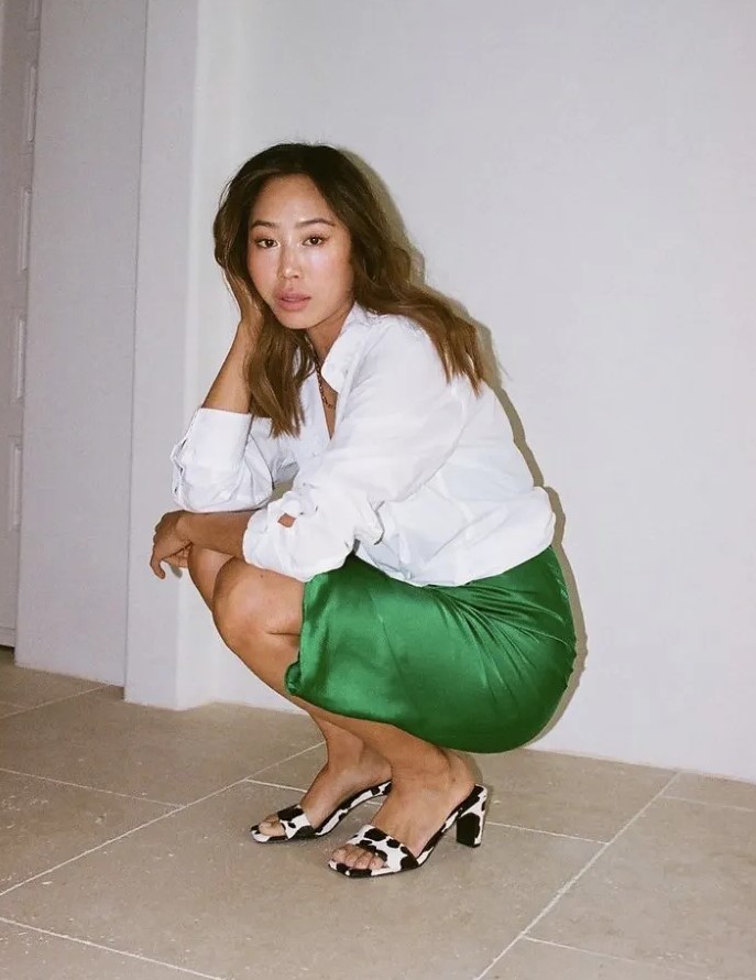 an emerald green slip dress, a white button down, animal print heeled sandals for a bold look at work