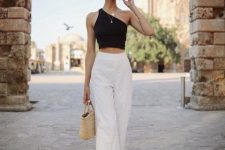 16 a black asymmetrical crop top, white high waisted pants, black strappy shoes and a woven bag plus layered necklaces
