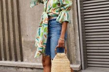 17 a bright tied up statement blouse with puff sleeves, blue denim shorts, brown heels and a woven bag with round handles