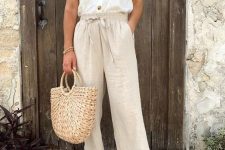 17 a cool summer look with a button top, neutral linen pants, gold slides and a staw bag and a hat is easy and comfy to wear